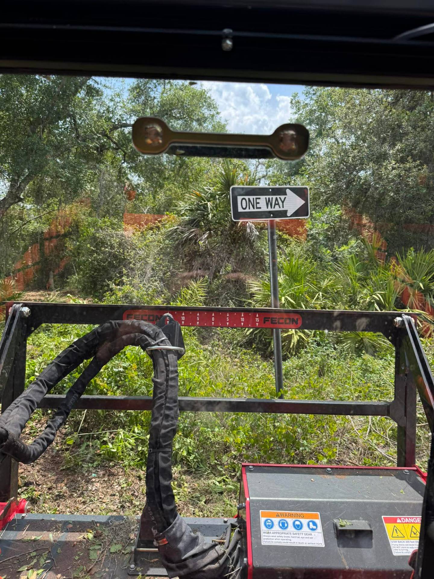 View from Fecon mulcher cab facing dense palmetto and overgrown brush ready to clear in Florida